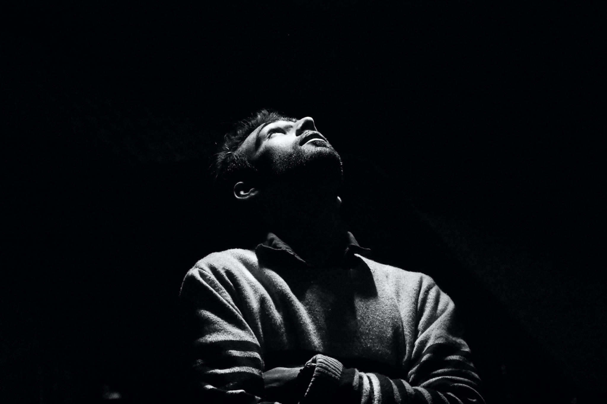 Monochrome photo of man looking up