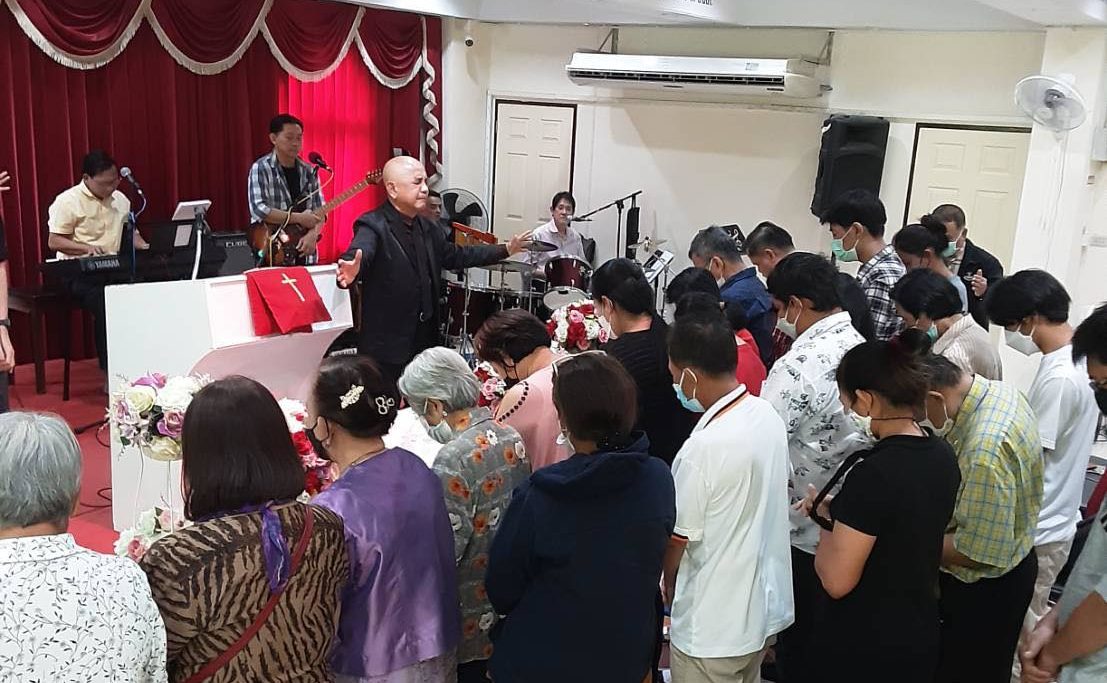 Albert praying for various needs of Don Miuang Church